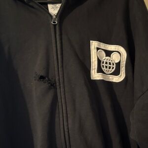 Black Hoodie with White Logo has a whole in the front
